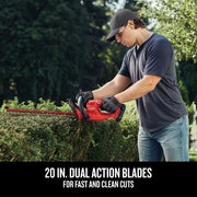 Photo of person using Craftsman hedge trimmer CMCHT810C1 with red 20-inch dual action blades trimming a hedge outdoors.