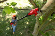 Photo of CRAFTSMAN pole pruner SKU CMCPPR320D1 trimming a tree branch outdoors, operated by a person wearing safety gear.