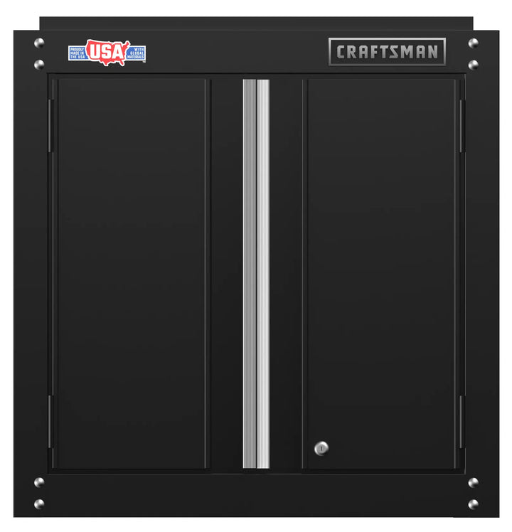 Black metal wall cabinet with two doors, vertical silver handle in the center, and labels reading 'USA' and 'Craftsman' on the top edge.