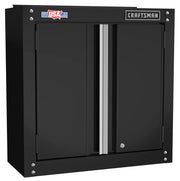 Black metal wall cabinet with two doors, featuring a silver handle in the center. The cabinet has a 'CRAFTSMAN' logo on the top right and a sticker showing 'USA' on the top left.