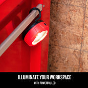 Photo of CRAFTSMAN LED work light CMST98187 hanging from handle, red and black design, workspace setting.