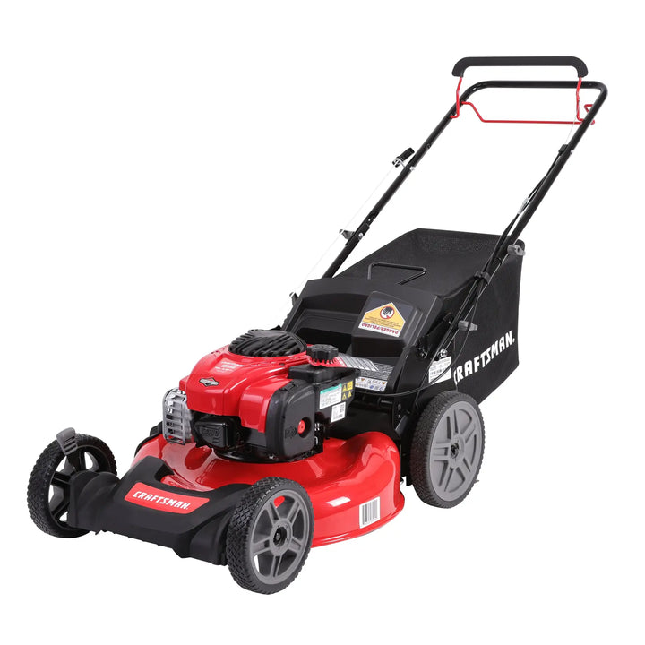 A CRAFTSMAN branded red and black gas-powered lawn mower with a grass collection bag attached at the back.
